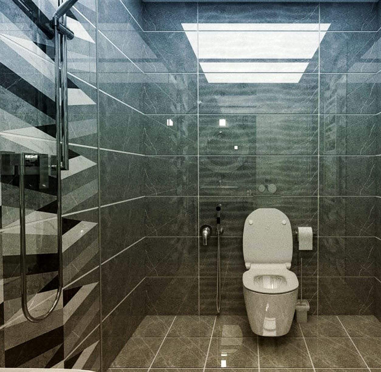 Tiled wet room in dark gray stone-look tile with a wall-hung toilet, a concealed tank flush plate, a bidet sprayer on a wall valve and a glass shower screen